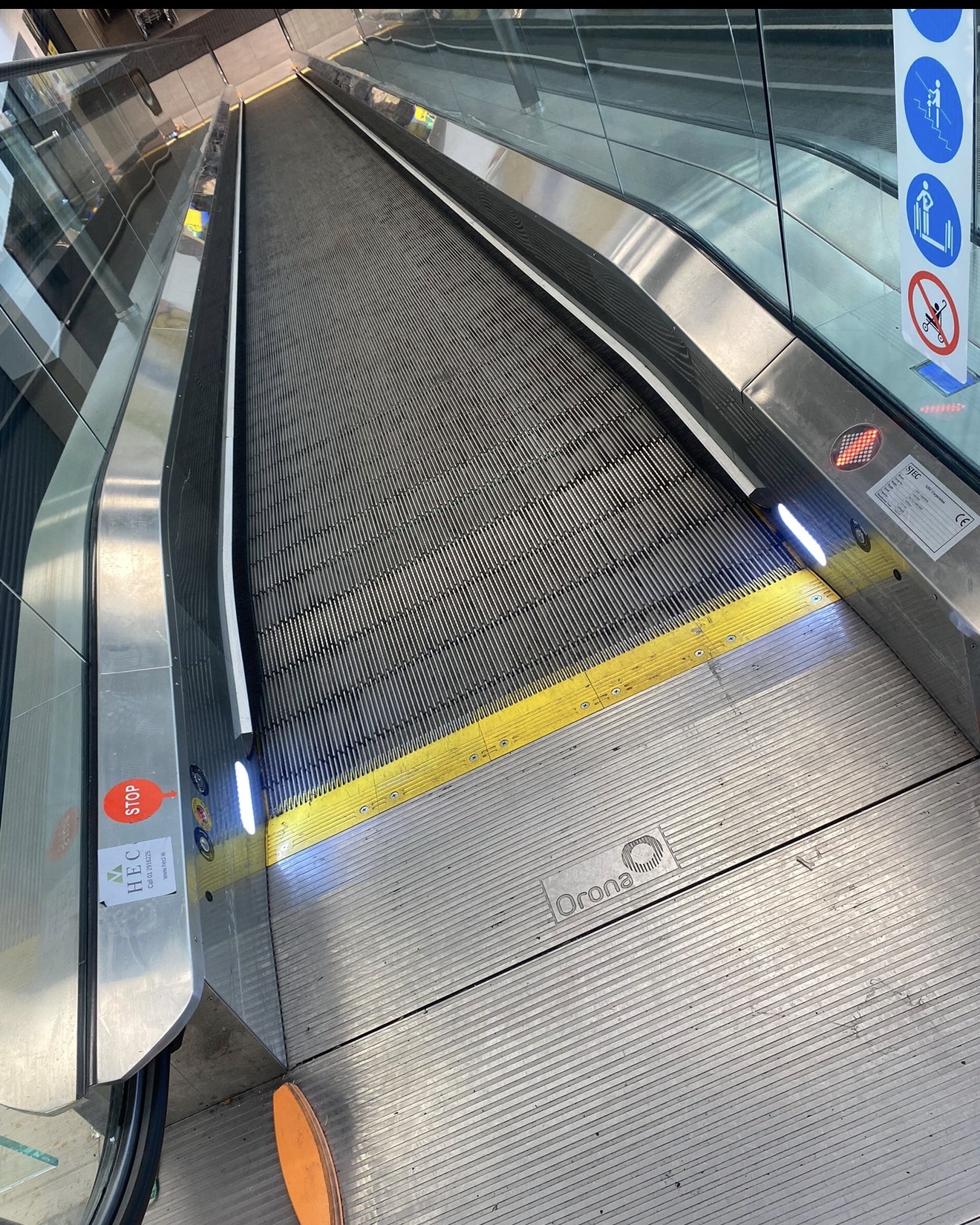 Travelator entrance with rubber belt, glass sides and handrails